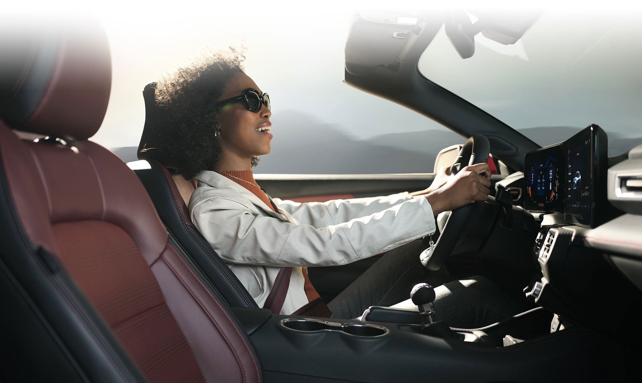 Person sitting in the driver’s seat of a 2024 Ford Mustang® convertible | Jansen Ford of Breese in Breese IL